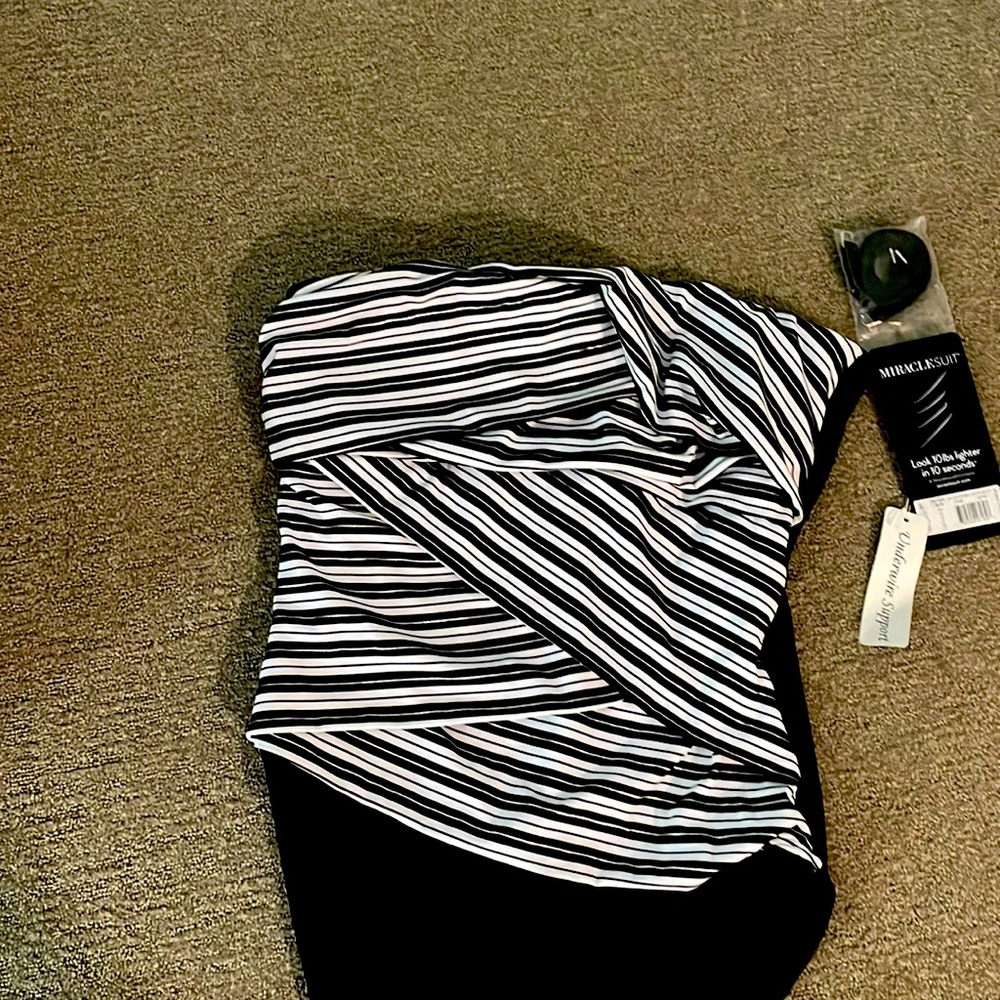 Luxury Miracle swim suit. Is a size 14. The suit is strapless. Includes a strap.